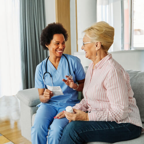 Doctor or nurse caregiver showing a prescrption drug bottle