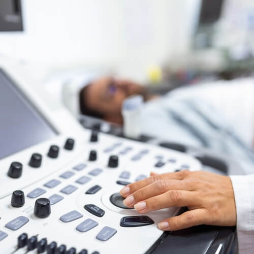 Young male patient lying on bed and having ultrasound examination
