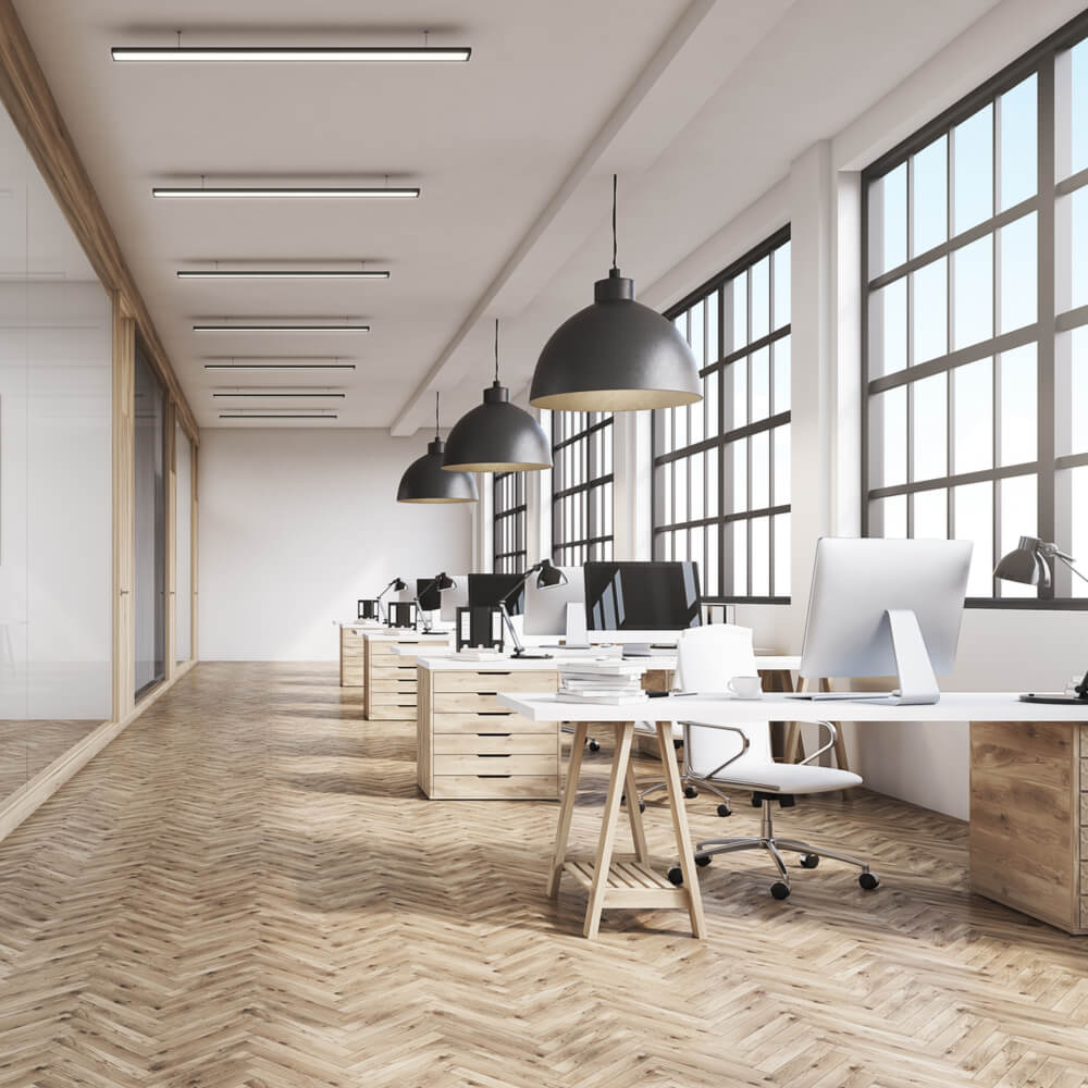 Front view of an office interior with a row of dark wood tables