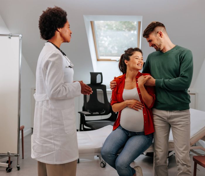 A joyful pregnant Caucasian woman is with her husband