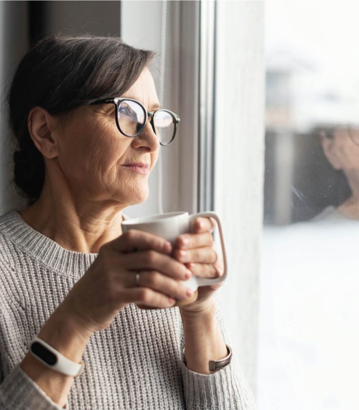 Close-up portrait of senior older woman wearing glasses